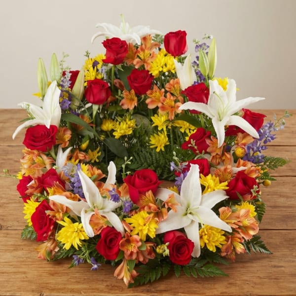 Mixed bouquet with red roses, white lilies, and yellow daisies