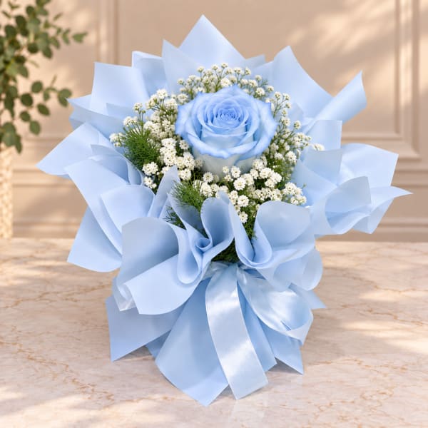 Blue rose bouquet wrapped in pale blue paper with white filler flowers