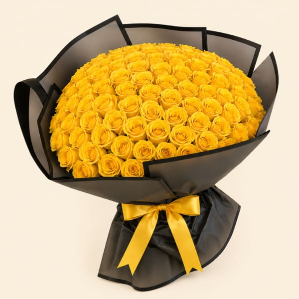 Large bouquet of yellow roses wrapped in black paper with a yellow ribbon