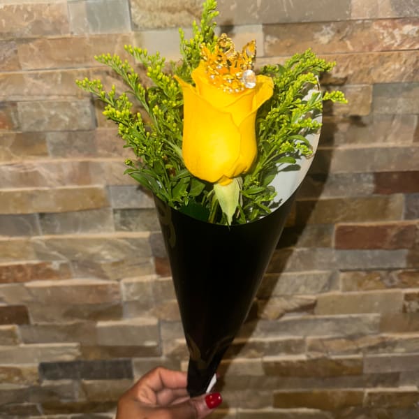 Single yellow rose bouquet with greenery in black wrap