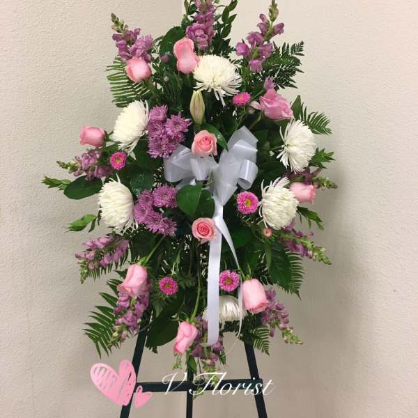 Standing floral spray with pink and white flowers on an easel