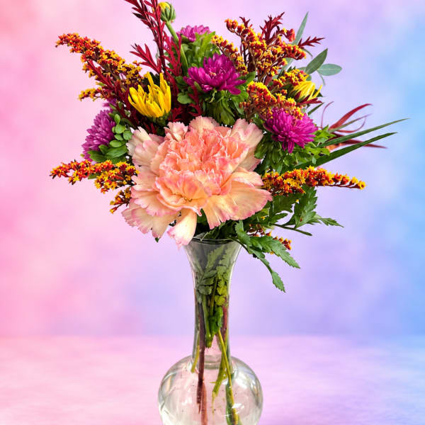 Colorful bouquet of mixed flowers in a clear glass vase