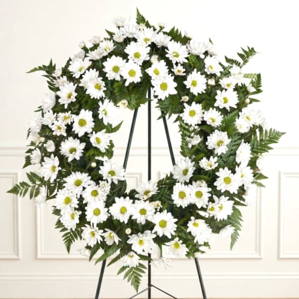 White daisy wreath on a black stand