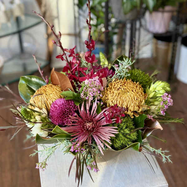 Mixed bouquet with pink and yellow blooms in a low arrangement