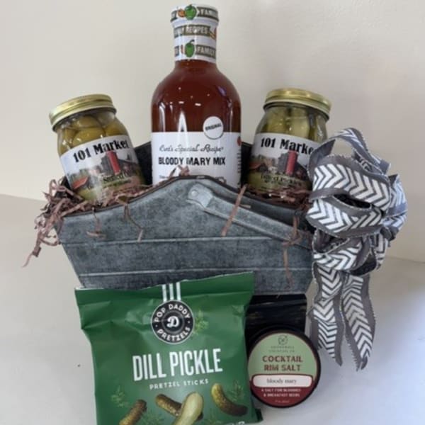 Gift basket with Bloody Mary mix, pickles, pretzels, and a ribbon bow