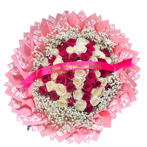 Round bouquet of pink and white roses with pink wrapping and ribbon