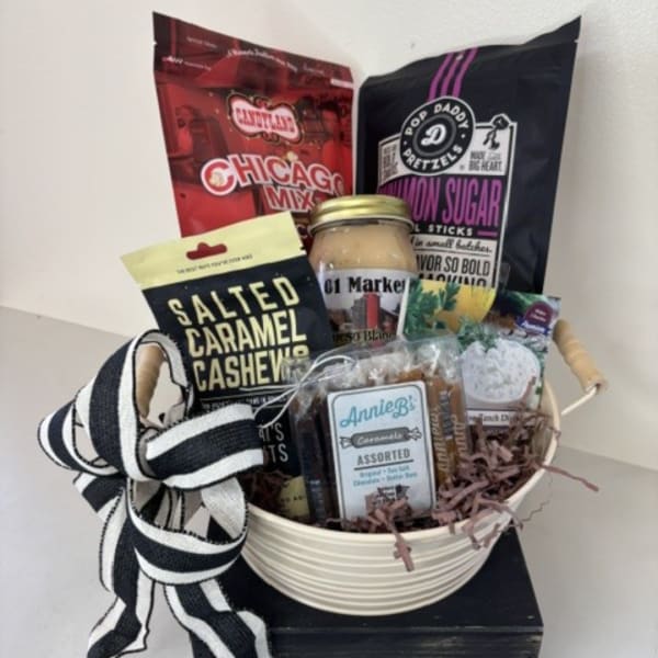 Gift basket with assorted snacks and a black-and-white ribbon bow