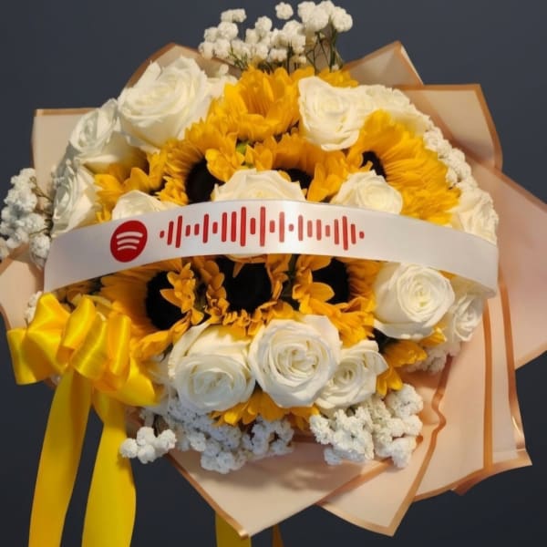 Bouquet of white roses and yellow sunflowers with a yellow ribbon