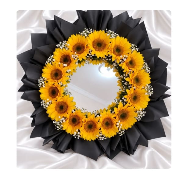 Sunflower wreath with white filler flowers and black wrapping
