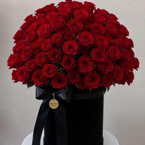 Large bouquet of red roses in a black box with a ribbon