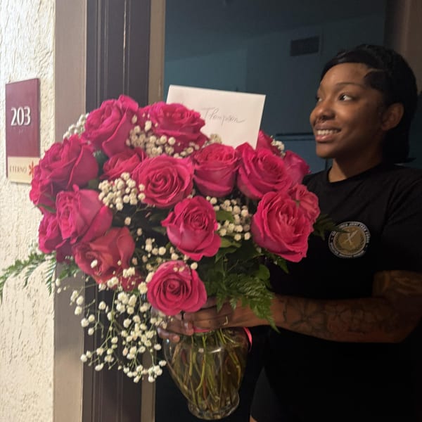 Large bouquet of hot pink roses in a glass vase
