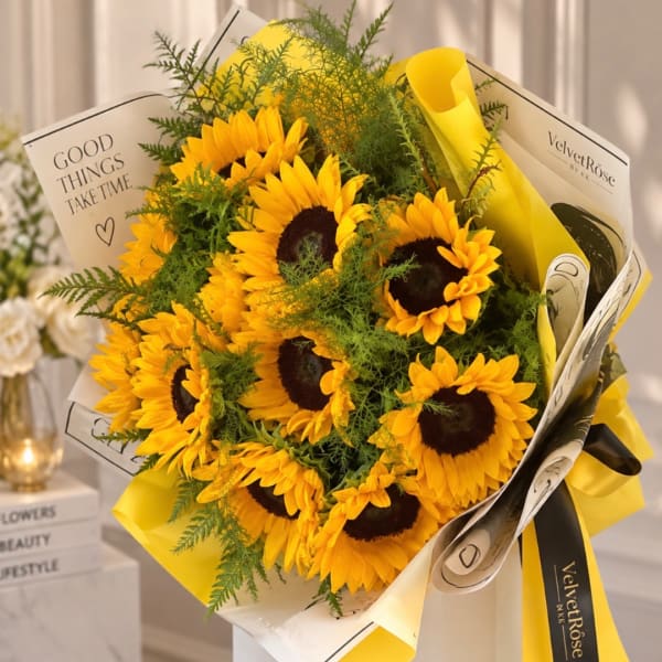 Bouquet of yellow sunflowers wrapped in white and yellow paper