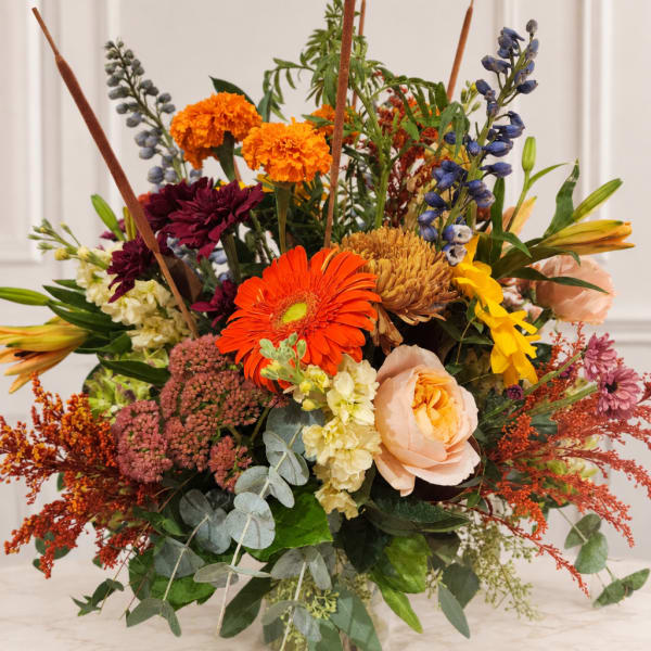 Mixed bouquet with orange, peach, purple, and blue flowers