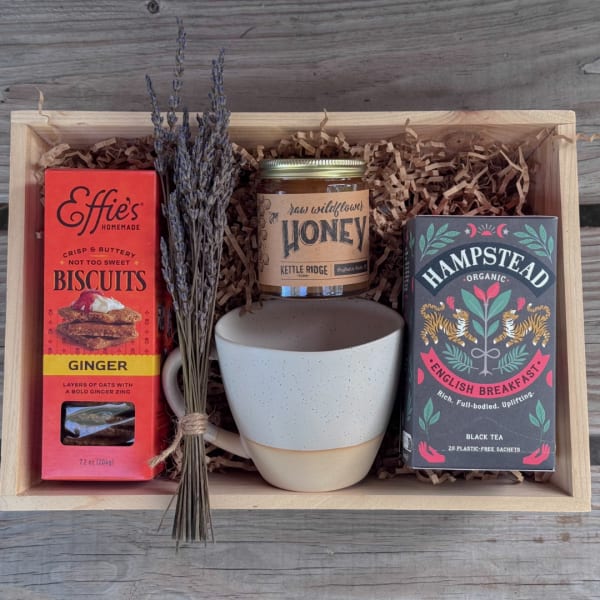 Gift box with tea, biscuits, honey, a mug, and dried lavender