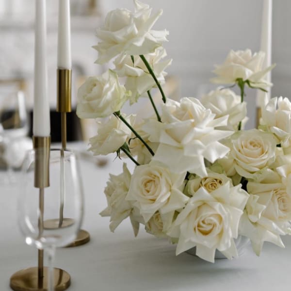 White rose bouquet with star-shaped blooms in a low vase