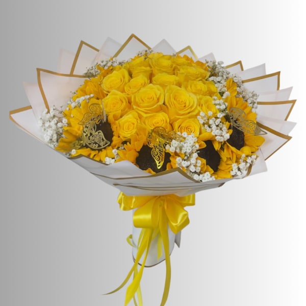 Yellow rose bouquet with white filler flowers and a satin ribbon wrap