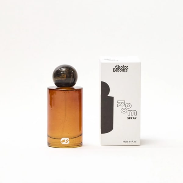 Amber perfume bottle beside a white product box