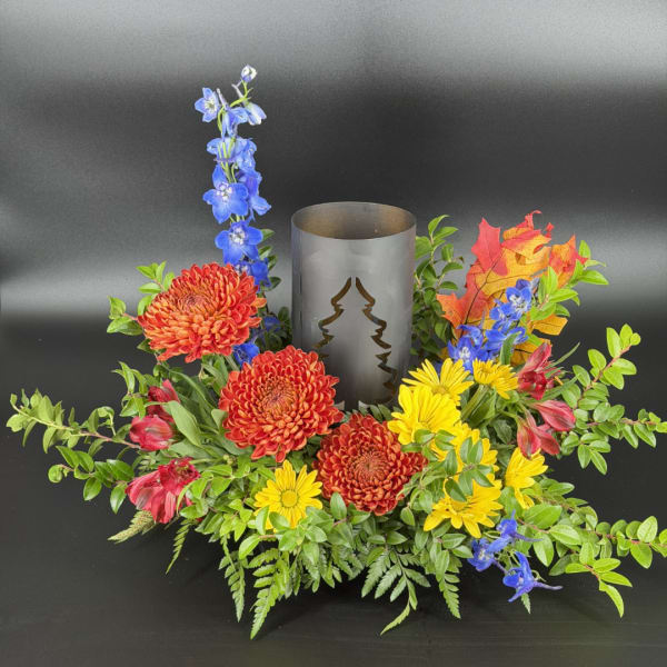 Autumn floral centerpiece with chrysanthemums and a metal candle holder
