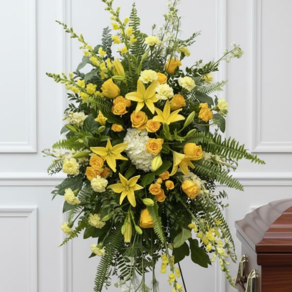 Yellow flowers and roses arranged on a standing spray easel