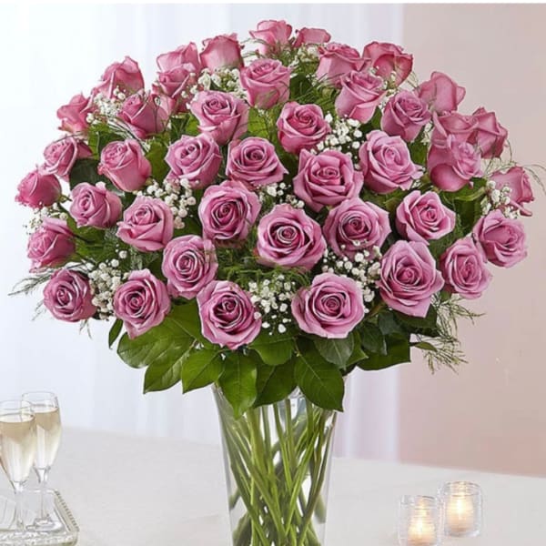 Pink roses arranged in a clear glass vase