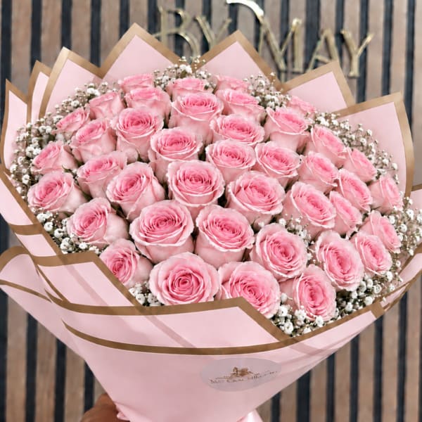 Bouquet of pink roses wrapped in pink and brown paper