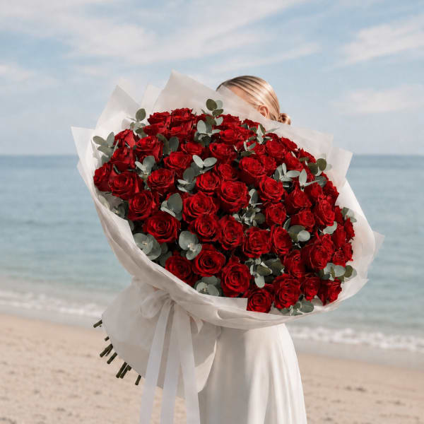 Large bouquet of red roses wrapped in white paper