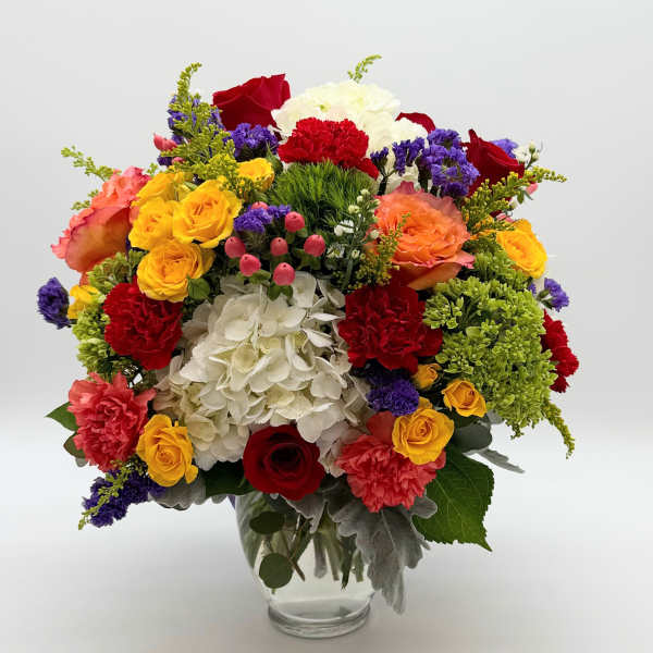 Colorful mixed flower bouquet in a clear glass vase