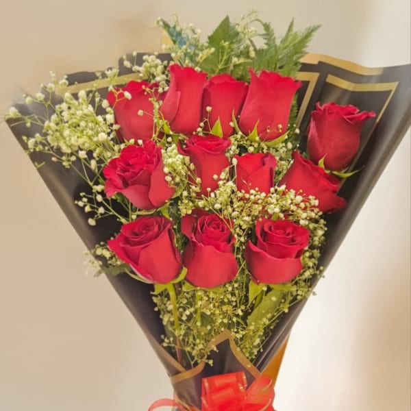 Bouquet of red roses with baby's breath in black wrap