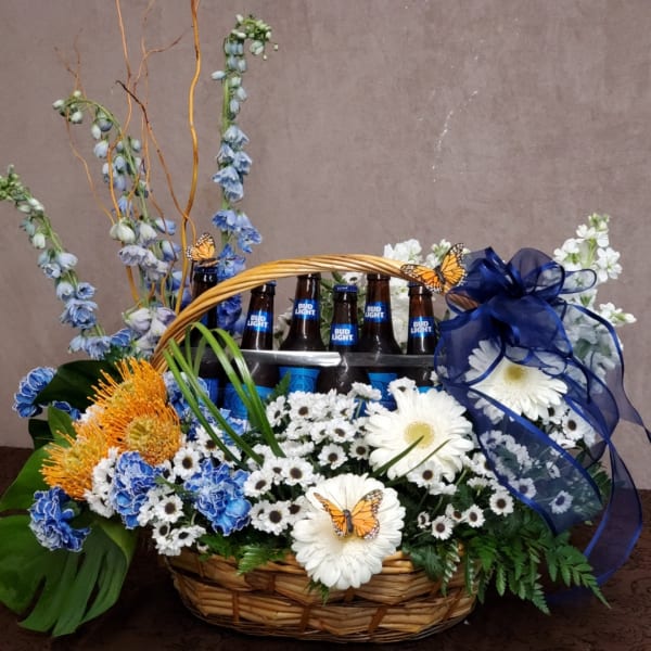 Basket arrangement with flowers and Bud Light bottles, tied with a blue ribbon