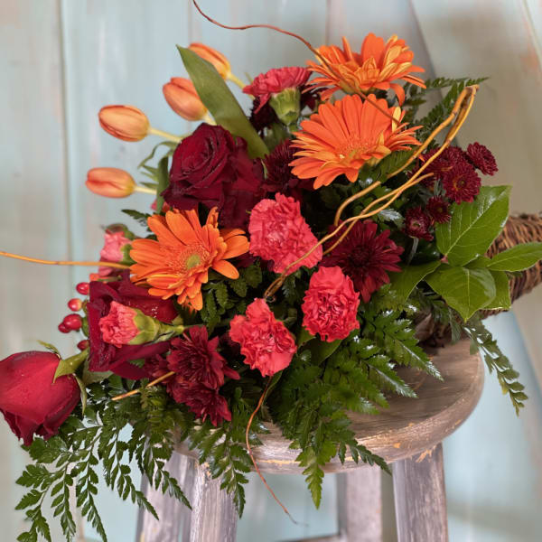 Bouquet of orange gerbera daisies, red roses, and pink carnations