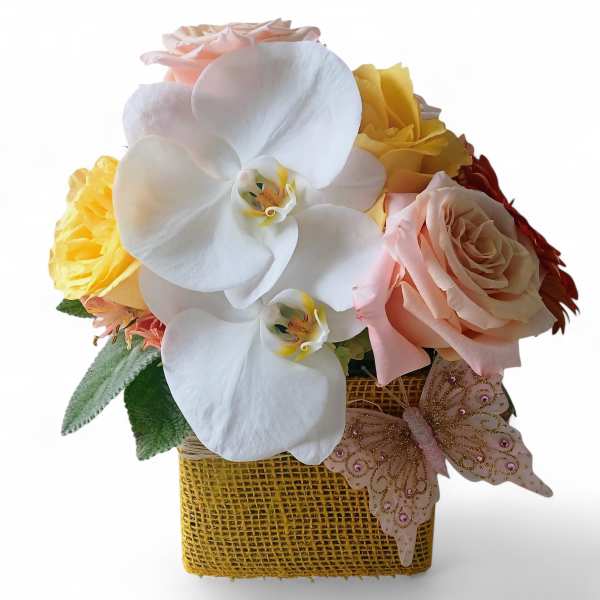 Bouquet with white orchids, pink roses, and yellow flowers in a square basket
