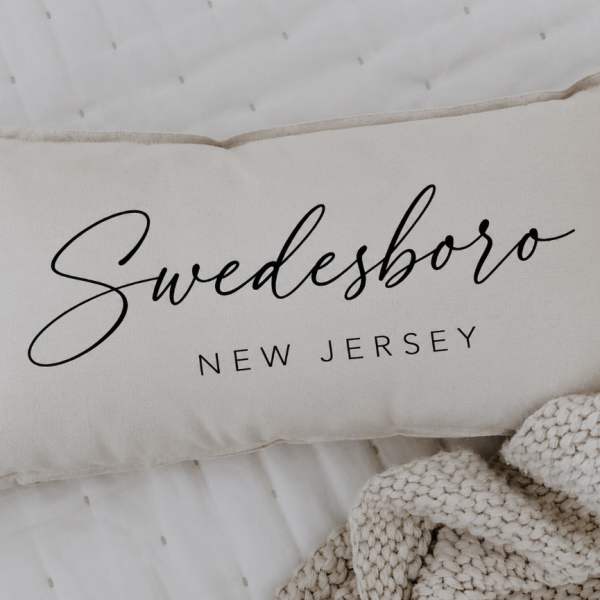 Cream pillow with the word "Swedesboro" printed on it