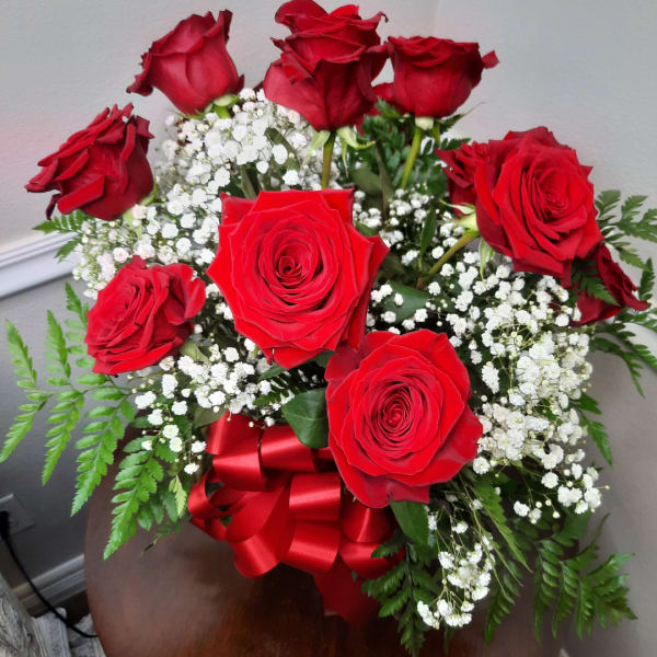 Bouquet of red roses with white baby's breath and a red ribbon