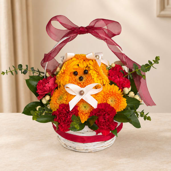Basket arrangement of yellow and red flowers shaped like a teddy bear