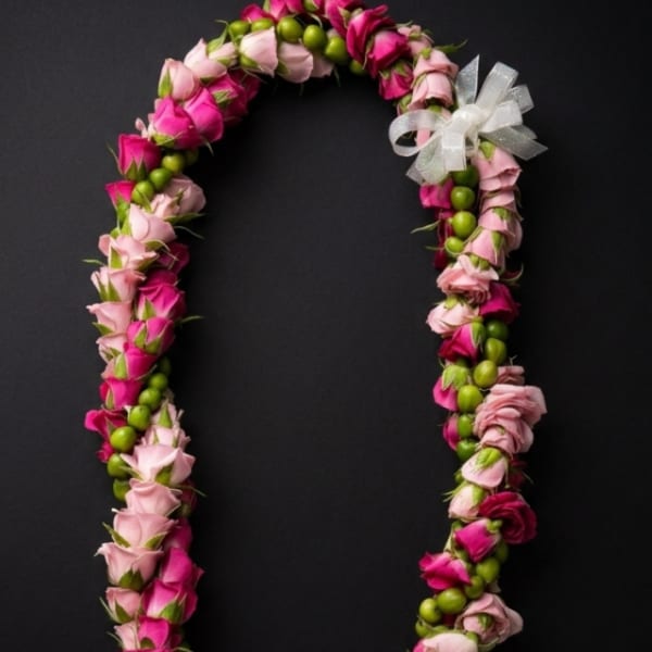 Pink and magenta rose lei with a white ribbon bow