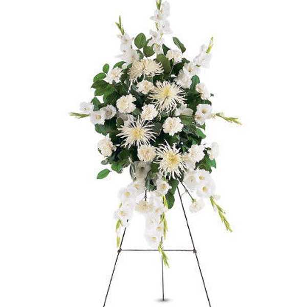 White floral standing spray on a metal easel