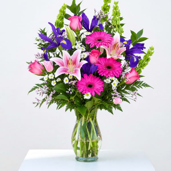 Pink and purple mixed bouquet in a clear glass vase