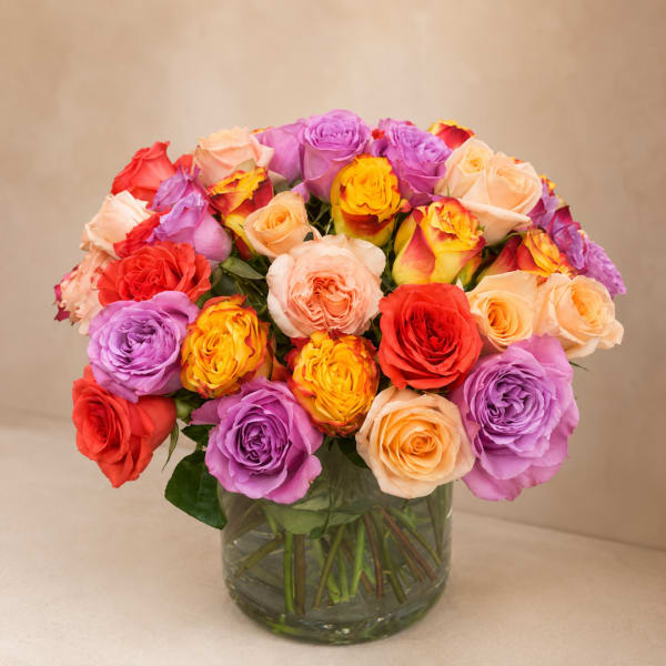 Mixed roses in a clear glass vase