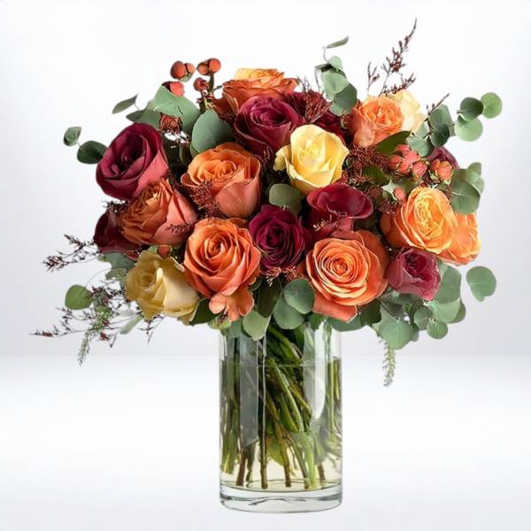 Bouquet of multicolored roses in a clear glass vase