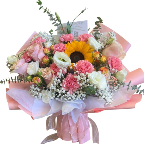Bouquet of pink and white flowers with a sunflower in pink wrapping