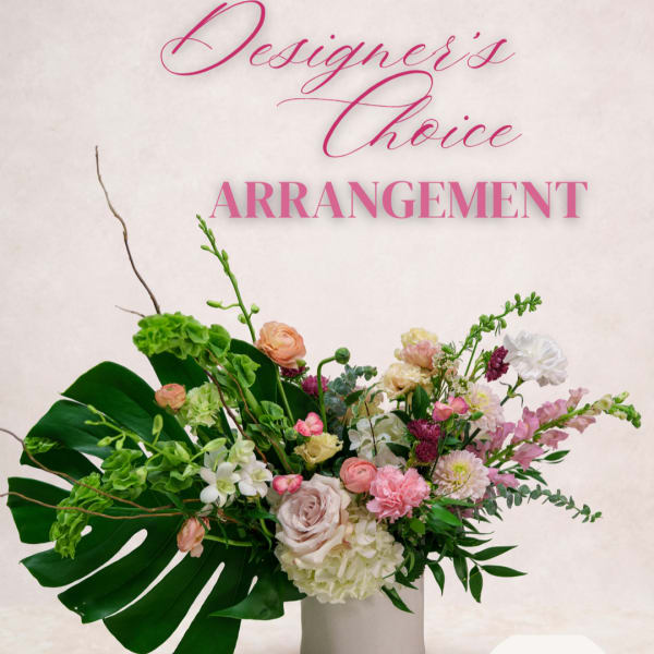 Mixed floral arrangement in a white vase with pink and white blooms