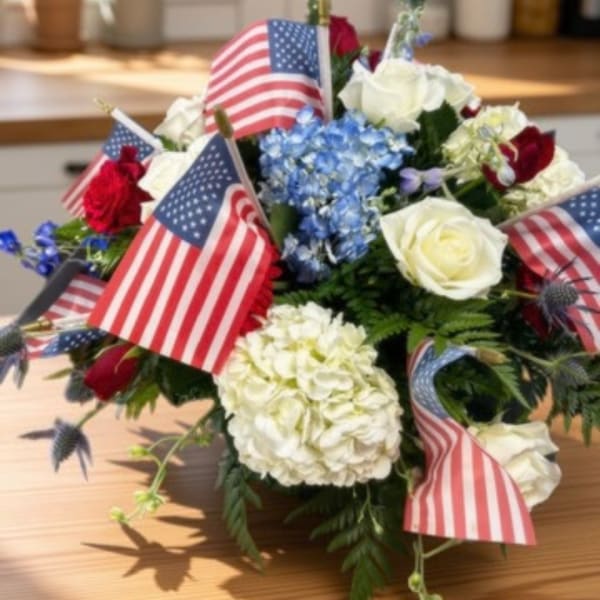 Bouquet of red, white, and blue flowers with small American flags