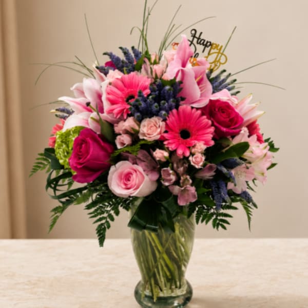 Pink and purple mixed bouquet in a clear glass vase