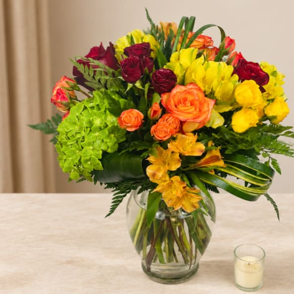 Colorful bouquet of roses and hydrangeas in a glass vase