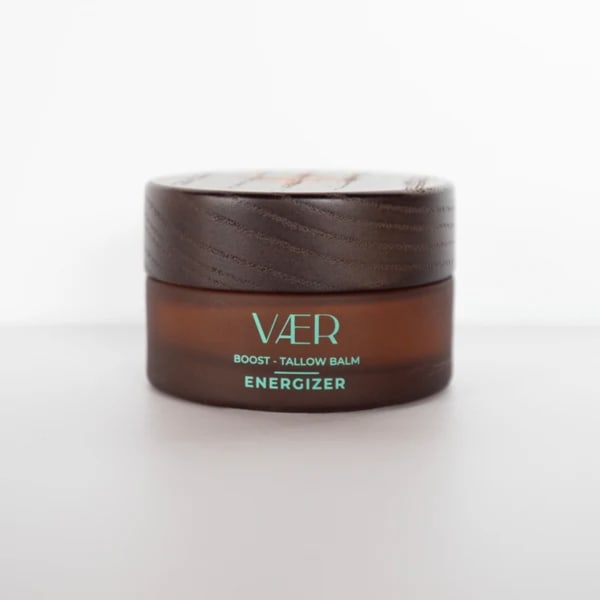 Brown balm jar with a wooden lid on a white background