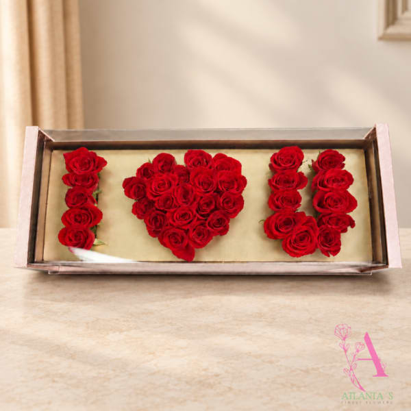 Red roses arranged to spell "I ♥ U" in a rectangular box