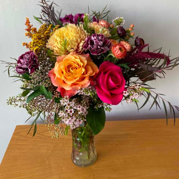 Mixed bouquet of roses and chrysanthemums in a glass vase