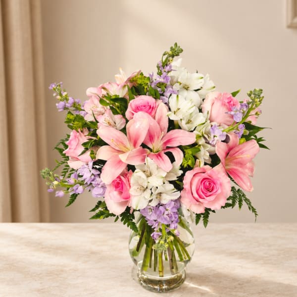 Pink and white mixed bouquet in a clear glass vase