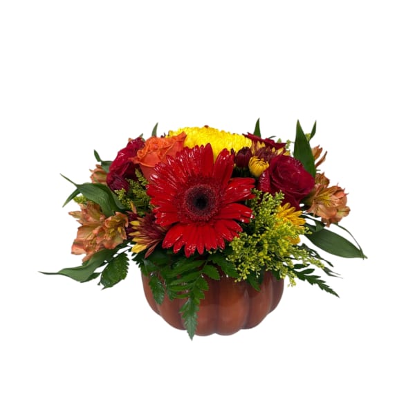 Mixed bouquet in a pumpkin-shaped container with red, yellow, and orange flowers