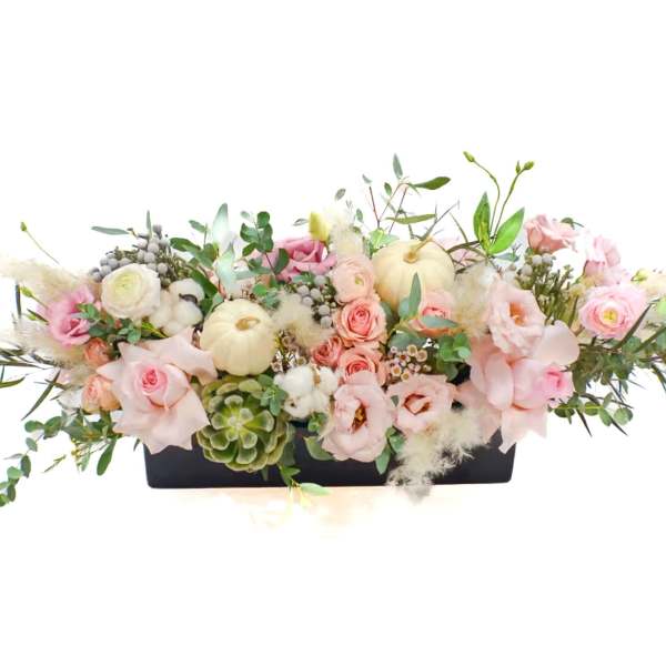 Low floral centerpiece with pink and white blooms in a black rectangular container